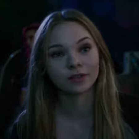 Taylor Hickson is looking at someone with few girls in the background.